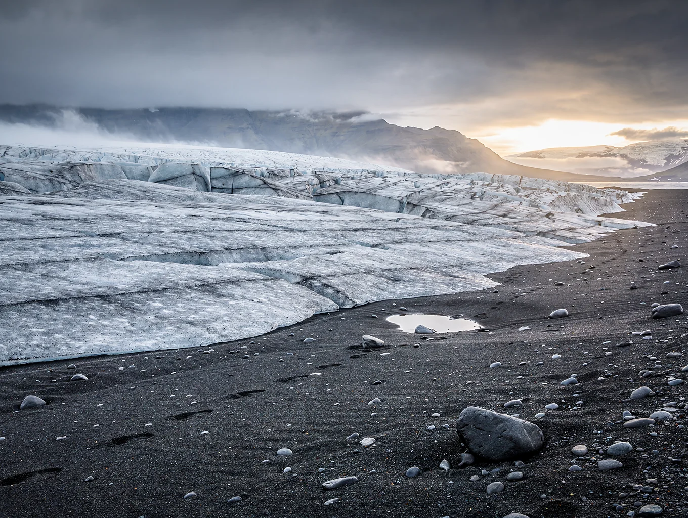 Black volcanic sand plains with glacial river braids in Iceland